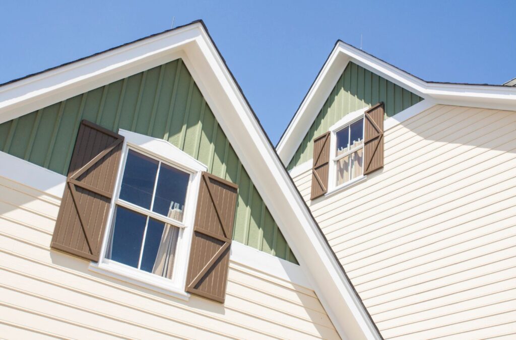 Image of a Sunrise Remodelers team member installing durable siding on a home in Twin Cities, MN. Expert siding solutions tailored to local conditions.