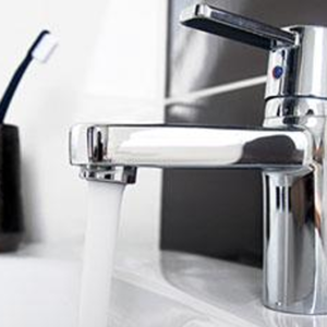 Modern bathroom in Maple Grove, MN, featuring a low-flow toilet and water-efficient faucet.